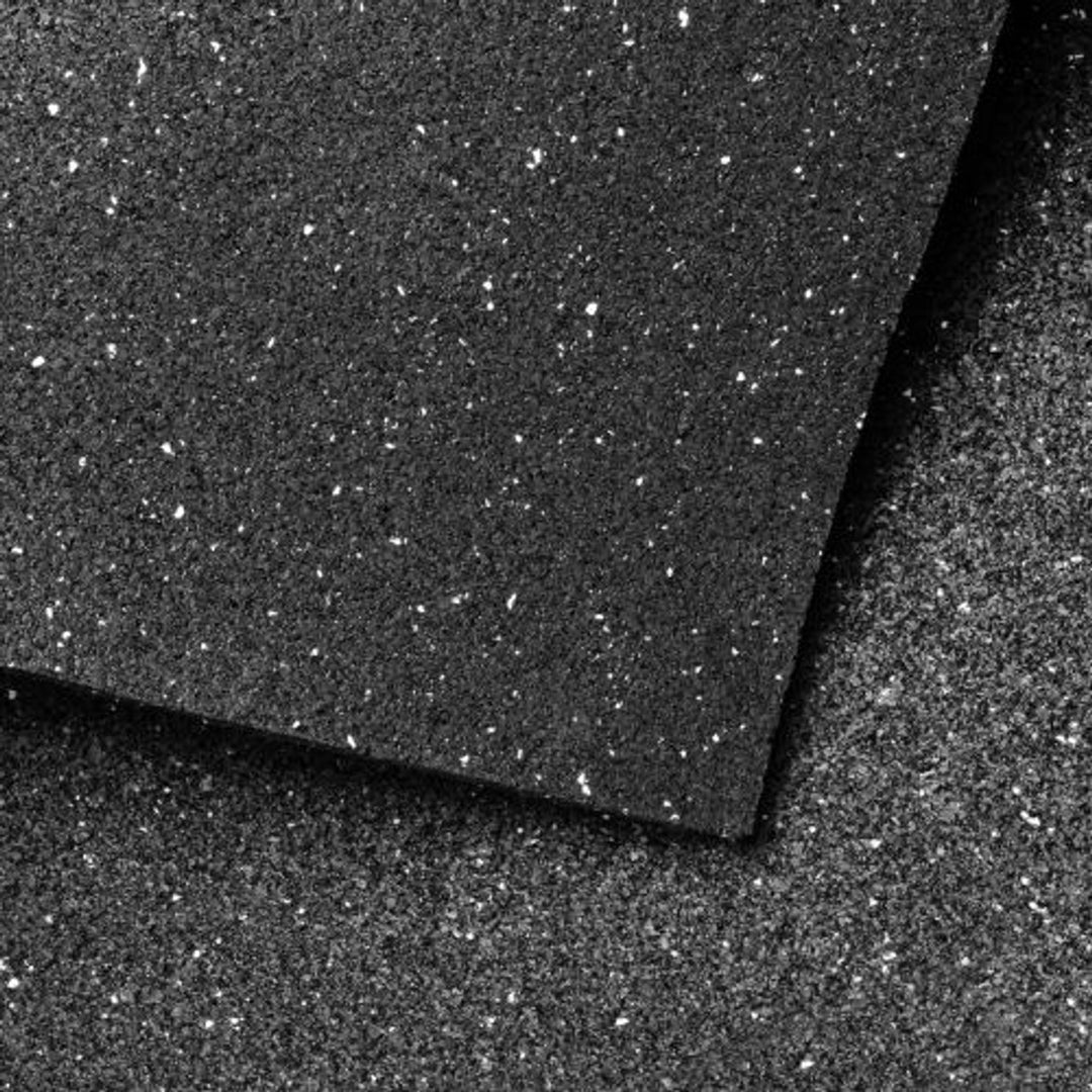 Close-up view of recycled rubber acoustic floor underlay with a folded-over edge showing textured surface.