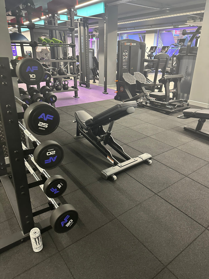 SilentTile 30mm Acoustic Gym Flooring Fitness Interlocking Tile featured in a modern gym setting, offering soundproof and noise reduction benefits with sturdy rubber-coated dumbbells and adjustable bench in the foreground.