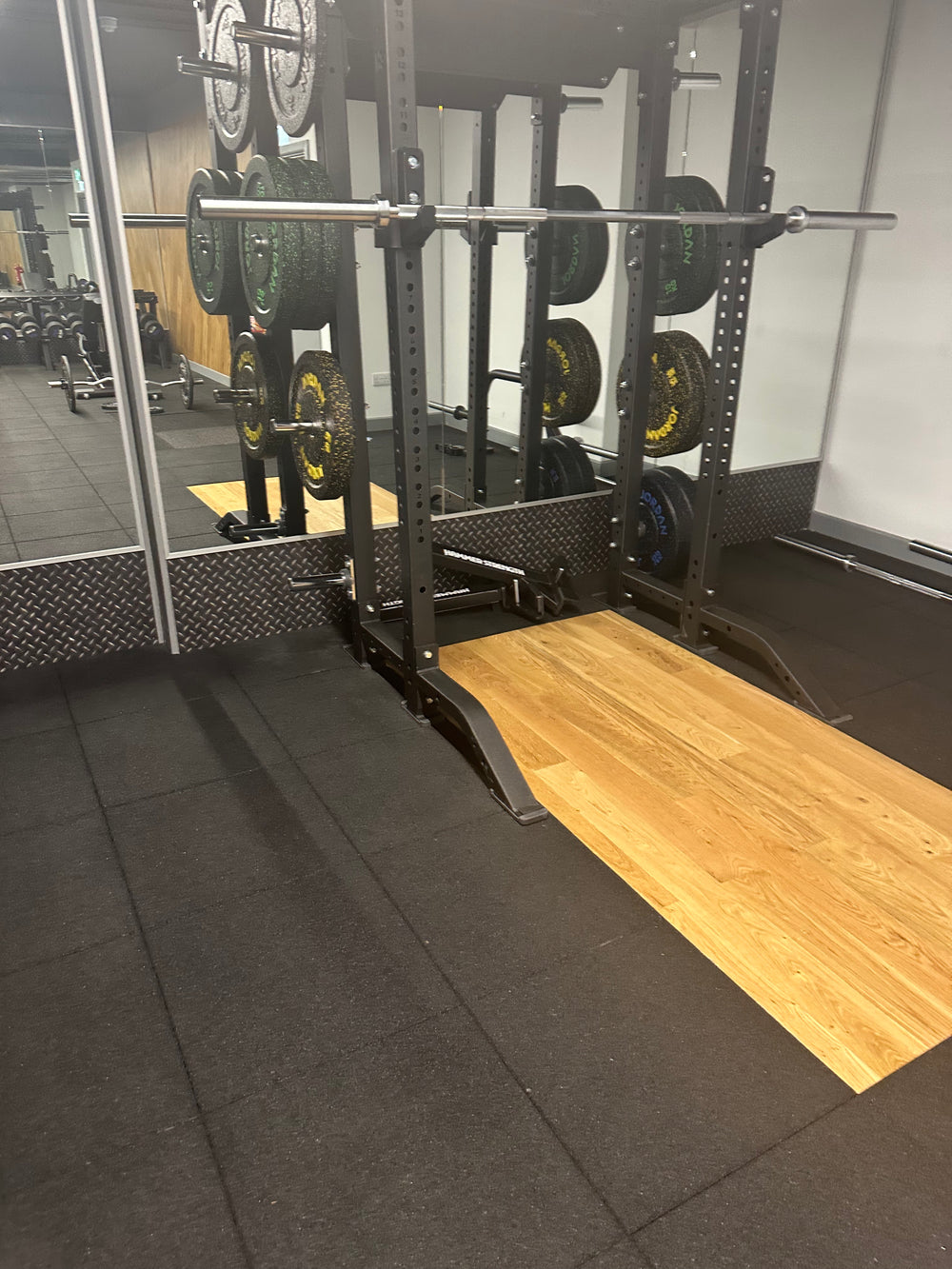 SilentTile 30mm Acoustic Gym Flooring Fitness Interlocking Tile in a weight-training room, showcasing soundproof, noise-reducing capabilities with durable, interlocking design beneath a power rack, ideal for sound insulation and vibration damping.
