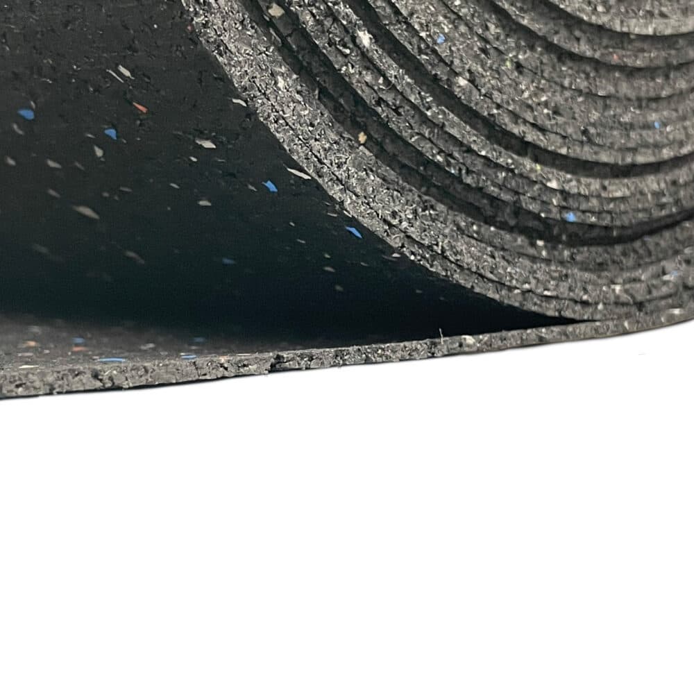 Close-up of rolled recycled rubber soundproofing underlay with speckles, showing inner layers and textured surface