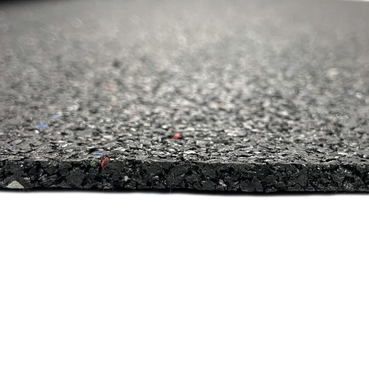 Edge view of recycled rubber acoustic soundproofing underlay sheet showing thickness and crumb texture