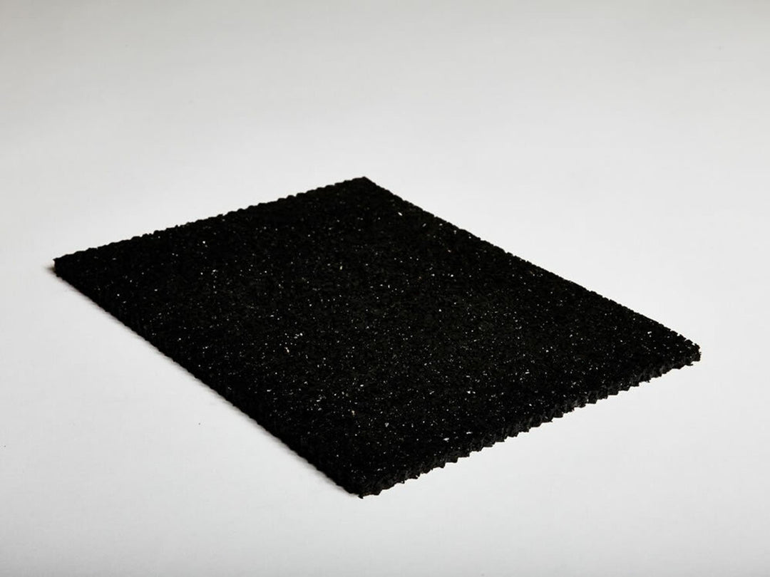 Sample piece of hush under screed acoustic soundproofing membrane shown on white background, illustrating texture and thickness