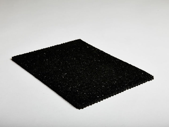 Sample piece of hush under screed acoustic soundproofing membrane shown on white background, illustrating texture and thickness