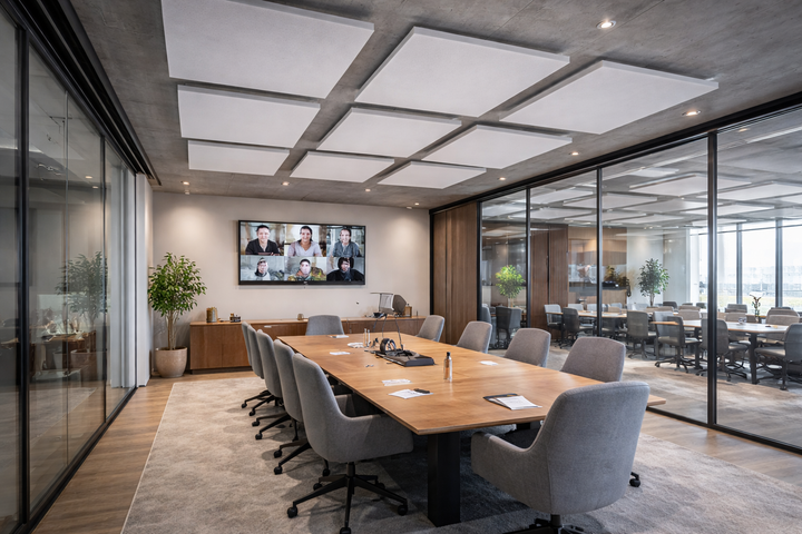 Silent Cloud EchoAbsorb Acoustic Panels adorn the ceiling, enhancing soundproofing and noise reduction in the conference room with their high-performance acoustic and sound insulation properties, demonstrating Sound Deadening UK's expertise.